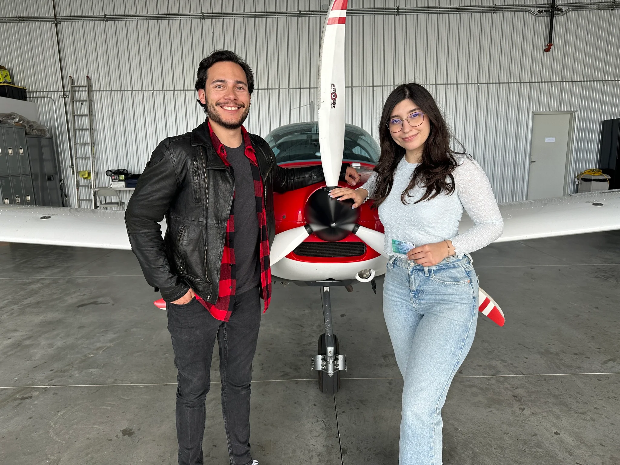 Student and instructor next to a training aircraft