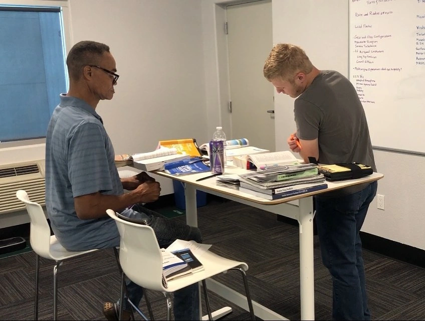 Student studying with a flight instructor